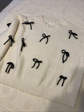 Cream Crewneck Sweater with Black Bow Appliqués, soft and comfy, mild piling